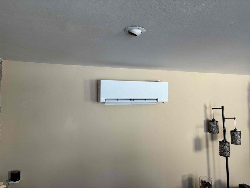 Successfully installed a Mitsubishi mini-split system in client's residence, including interior wall-mounted air handler and exterior heat pump condenser secured to stone veneer wall. Completed all electrical connections and refrigerant line installations between indoor and outdoor units, ensuring proper system operation and adherence to manufacturer specifications.