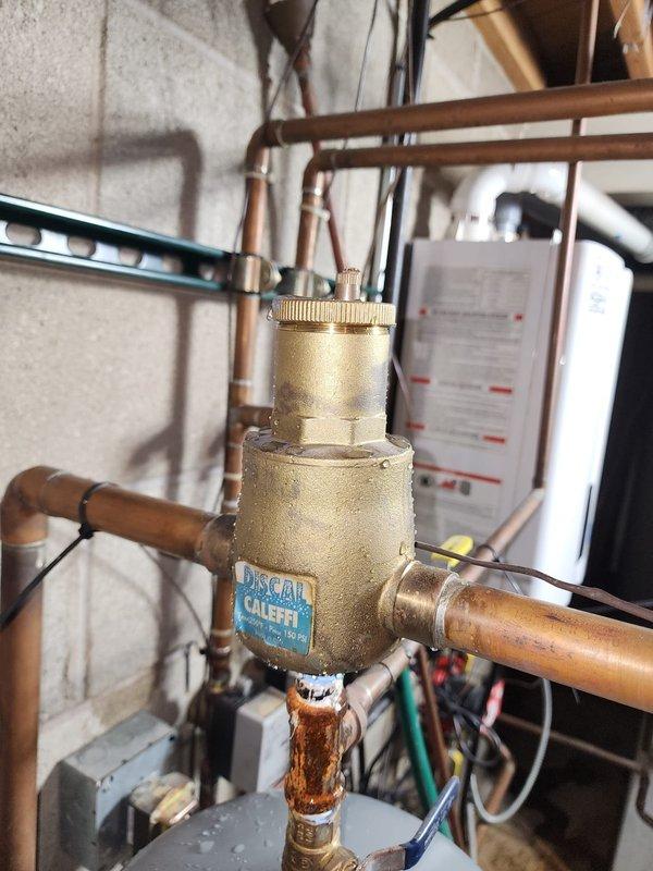 Performed inspection and service on plumbing infrastructure in utility area. Identified corrosion on copper piping connection to Caleffi brass valve/regulator assembly. Documented condition of PVC pipe junctions and metal fixtures in crawlspace/ceiling area for future maintenance recommendations.