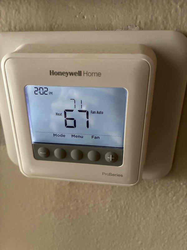 Performed routine inspection of HVAC system, examining the galvanized sheet metal ductwork in the utility space for proper installation and integrity. Verified operation of Honeywell Home ProSeries thermostat, confirming heating mode functionality with system set to 67°F and fan in auto mode.