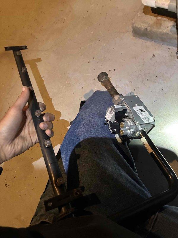 Performed furnace inspection and maintenance in utility room. Identified and replaced a worn mounting bracket on the gas valve assembly. System was tested and confirmed to be operating correctly after repair.