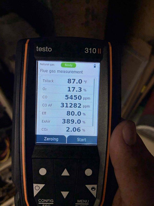 Conducted combustion analysis on heating system using Testo 310 II analyzer, revealing critical safety concerns including dangerously elevated carbon monoxide levels (5450 ppm) and signs of significant heat exchanger deterioration. Visual inspection confirmed severe corrosion and rust damage to the heat exchanger components, indicating immediate replacement is necessary to prevent carbon monoxide leakage into living space.