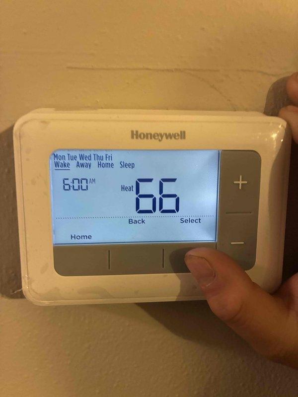 Completed thermostat inspection and programming check on Honeywell digital programmable thermostat. Verified proper operation of heat mode, confirmed temperature settings were correct at 62°F for evening and 66°F for morning, and validated scheduled programming functionality across weekday settings.