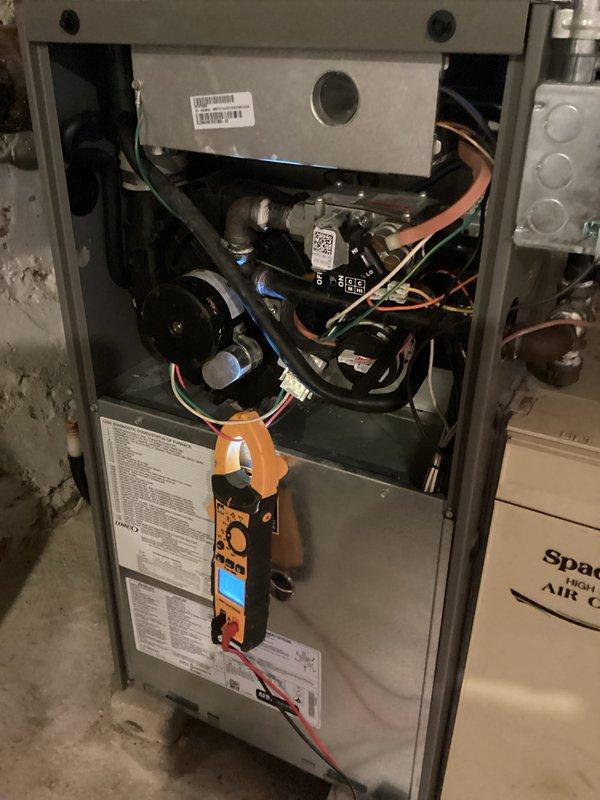 Performed comprehensive furnace tune-up which included removing access panel for full component inspection. Conducted electrical testing with clamp meter to verify proper voltage and amperage readings on control board and wiring connections. Measured gas pressure using digital manometer, confirming readings of 3.50/3.45 inWC, which are within manufacturer specifications for this unit. All diagnostic tests indicate system is operating correctly with no issues detected.