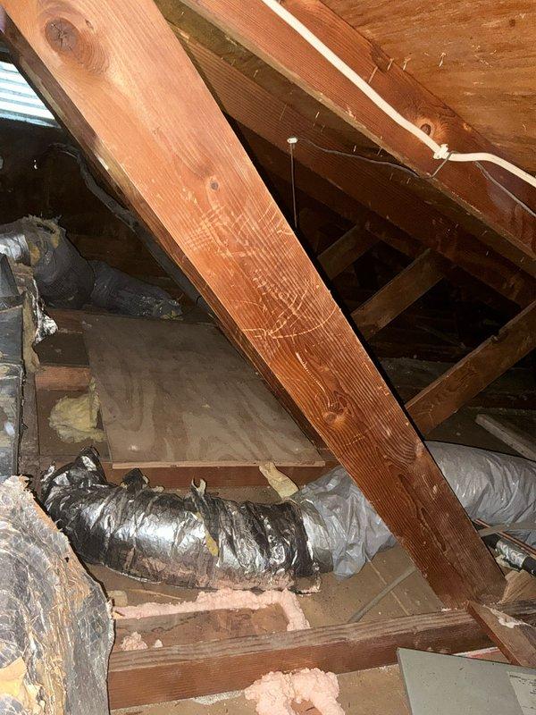 Conducted comprehensive inspection of attic space to evaluate HVAC replacement requirements. Examined existing ductwork condition and insulation quality, noting areas where flexible insulated ducts were installed. Assessed structural clearances and support beams to determine optimal positioning for new system components.