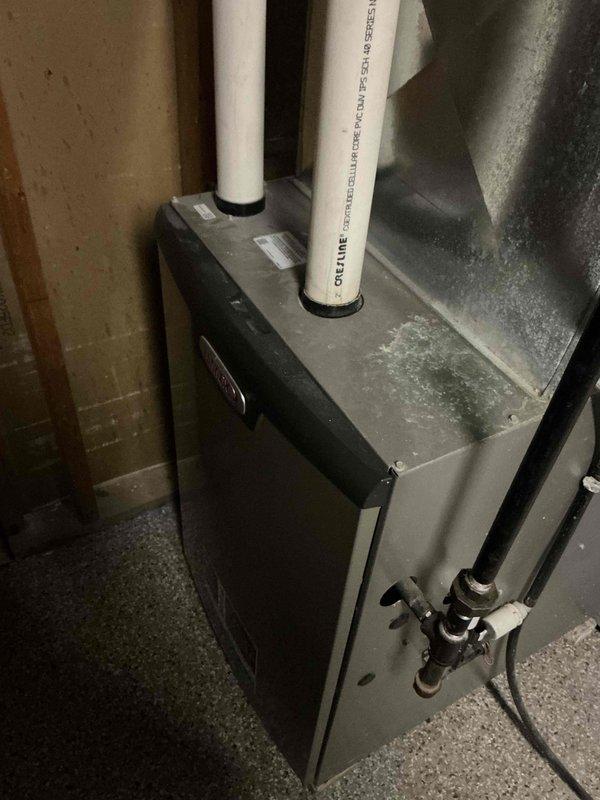 Completed routine prepaid maintenance service on client's HVAC system. Inspected utility room heating unit with PVC condensate drainage pipes and copper connections; all components operational with moderate dust accumulation. Examined insulated ductwork/piping for integrity, noting proper sealing at connection points.