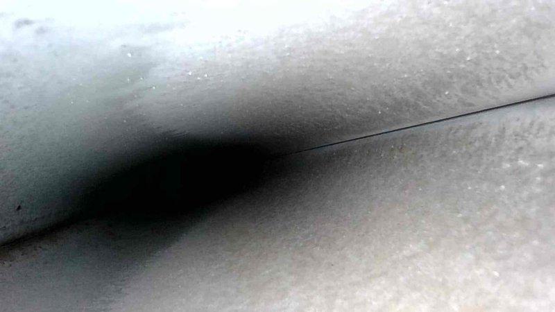 Completed routine prepaid maintenance service on client's HVAC system. Inspected utility room heating unit with PVC condensate drainage pipes and copper connections; all components operational with moderate dust accumulation. Examined insulated ductwork/piping for integrity, noting proper sealing at connection points.