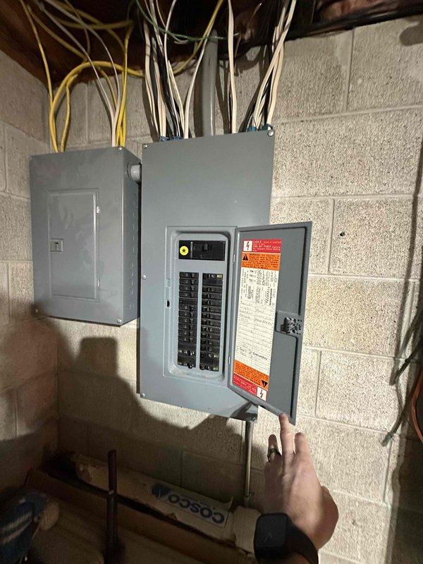 Completed HVAC system replacement in residential basement, including installation of a new furnace unit with proper ductwork connections and electrical panel updates. System was properly connected to existing return air housing and all electrical components were secured to code, with appropriate wiring routed through the utility space.