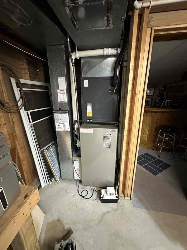 Completed HVAC system replacement in residential basement, including installation of a new furnace unit with proper ductwork connections and electrical panel updates. System was properly connected to existing return air housing and all electrical components were secured to code, with appropriate wiring routed through the utility space.