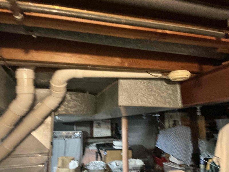 Conducted inspection of basement HVAC system, documenting existing metal ductwork and ventilation infrastructure. Evaluated current setup which includes rectangular metal ducts running through exposed ceiling joists, noting potential replacement needs. Photographed utility area to support replacement estimate preparation.