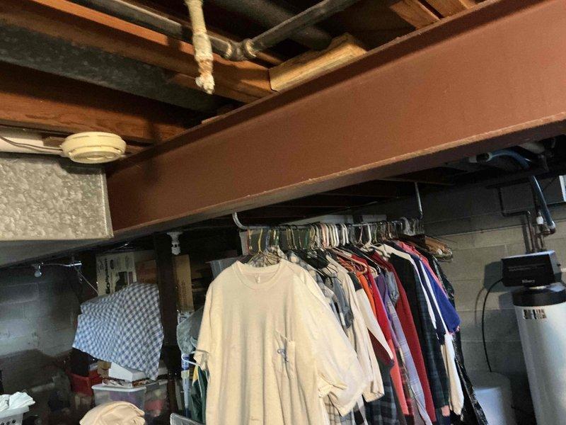 Conducted inspection of basement HVAC system, documenting existing metal ductwork and ventilation infrastructure. Evaluated current setup which includes rectangular metal ducts running through exposed ceiling joists, noting potential replacement needs. Photographed utility area to support replacement estimate preparation.