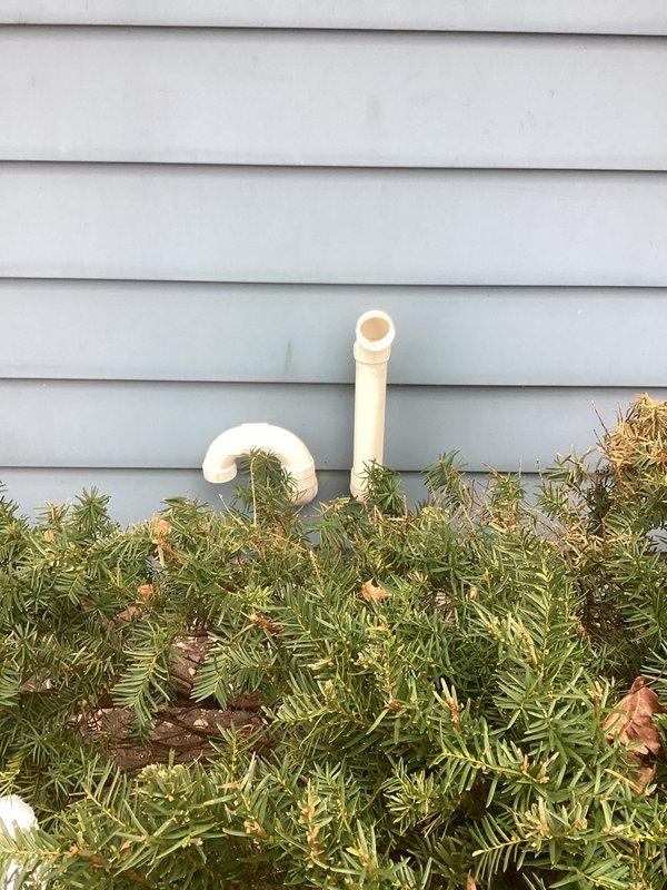 Completed installation of a new furnace system, including necessary drainage connections as evidenced by the concrete floor drain assessment. Verified proper exterior PVC venting configuration through the home's siding, ensuring code-compliant exhaust pathways for safe system operation.