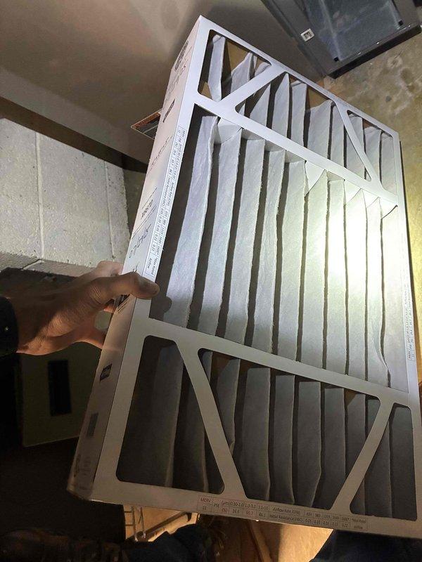 Completed routine HVAC system tune-up, which included inspection of equipment and replacement of air filter with new pleated filter. Noted damage to baseboard and wall junction with visible gap and water damage; flexible conduit was observed near the affected area requiring further assessment.