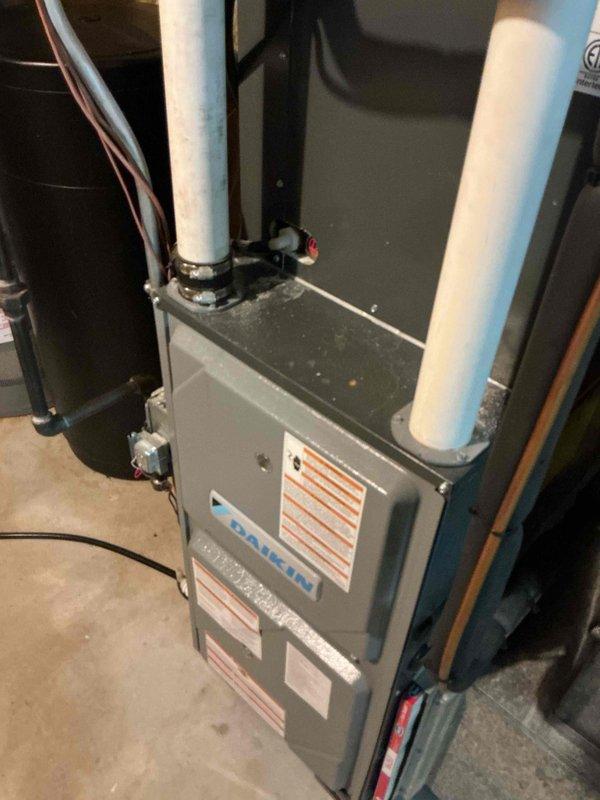 Performed routine preventative maintenance on Daikin furnace system. Inspected interior ductwork revealing minor dust accumulation and some yellowish-brown residue buildup on interior surfaces. Cleaned accessible components and verified proper operation of intake and exhaust PVC ventilation pipes.
