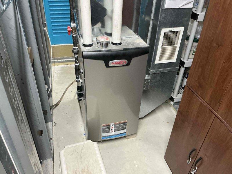 Performed assessment of existing HVAC system and proposed replacement of outdated Lennox furnace unit. Current installation includes standard sheet metal ductwork with diamond-shaped transition piece and PVC ventilation pipes. Recommended new high-efficiency system with proper connections to existing utility infrastructure in basement mechanical area.