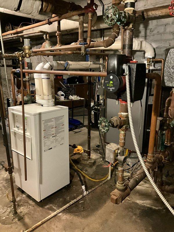 Conducted complete assessment of aging heating system in basement mechanical room. Identified significant corrosion on copper supply/return lines, deteriorated main valve assembly with rust development, and outdated circulation pump with failing digital control panel. Recommended full replacement of hydronic system components including piping infrastructure and control devices to prevent imminent system failure and improve operational efficiency.