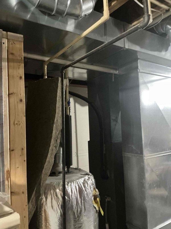 Conducted comprehensive assessment of electrical panel and HVAC infrastructure in basement utility area. Documented existing ductwork configuration and evaluated water heater/mechanical system connections. Prepared replacement estimate for complete HVAC system upgrade based on current installation conditions and building requirements.