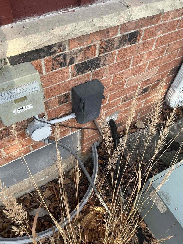 Conducted site assessment for HVAC replacement, including detailed measurements and sketches of the installation area. Documented existing electrical connections on exterior brick wall, noting ABB electrical box and junction box configuration. Observed evidence of wall deterioration that will need to be addressed during installation. Proposed system specifications were calculated based on square footage and building requirements.