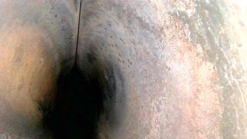 Performed routine maintenance tune-up on HVAC system, including inspection of ductwork. Interior duct examination revealed significant buildup of dust and potential soot accumulation on surfaces. Photos documented the condition of ductwork showing textured, discolored interior surfaces with possible mineral deposits and corrosion that may affect system efficiency.