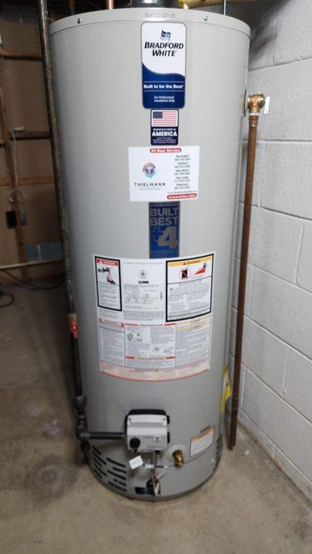 Completed installation of a Bradford White residential water heater in basement utility area. Installation included proper connection of copper piping, installation of expansion tank with control valves, and connection of metallic vent pipes. All components were professionally installed and tested to ensure proper operation.
