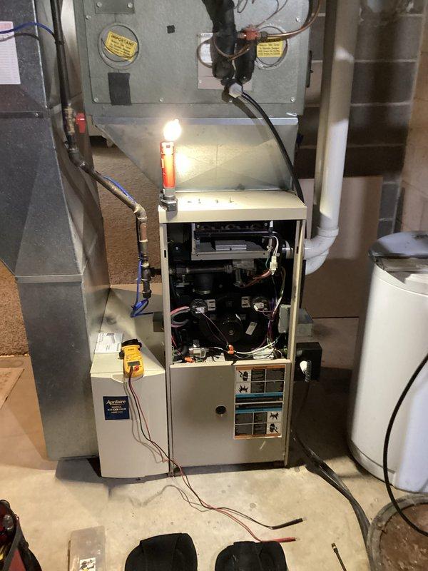 Performed comprehensive tune-up on residential furnace system including inspection of internal components, electrical connections, and control board. Removed front panel to access and clean interior machinery, verified proper wiring configuration, and ensured adequate insulation around adjacent ductwork. System was tested and confirmed to be operating within manufacturer specifications.