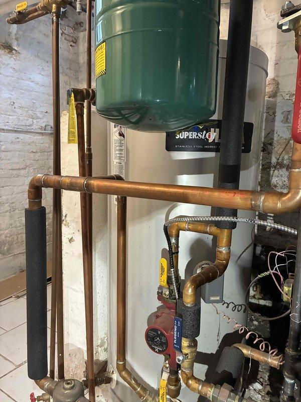 Performed comprehensive tune-up service on SuperStor stainless steel indirect water heater system with green expansion tank. Inspected and verified proper operation of the boiler control system showing normal parameters (Target: 92°, Energy Save On, Mod Efficiency On). Checked circulation pump functionality, confirmed proper insulation of piping network, and validated all mechanical components were operating within specifications. System left in optimal working condition with all safety features functioning correctly.