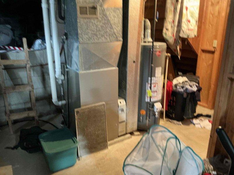 Performed comprehensive inspection of existing HVAC system in basement utility area. Evaluated aging furnace unit with connected ductwork, noting deterioration and inefficiency. Recommended complete system replacement to improve energy efficiency and reliability, with proper sizing of new equipment to match home's heating and cooling requirements.