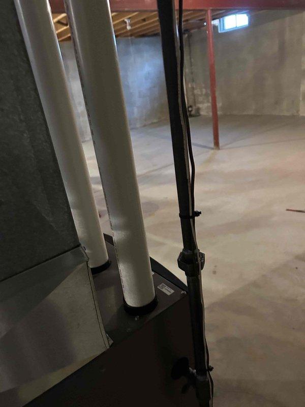 Successfully installed new furnace unit in basement location. Completed proper drainage system installation with PVC condensate lines and secured all connections. Ensured unit was properly positioned on concrete floor with appropriate clearance for ventilation and maintenance access.