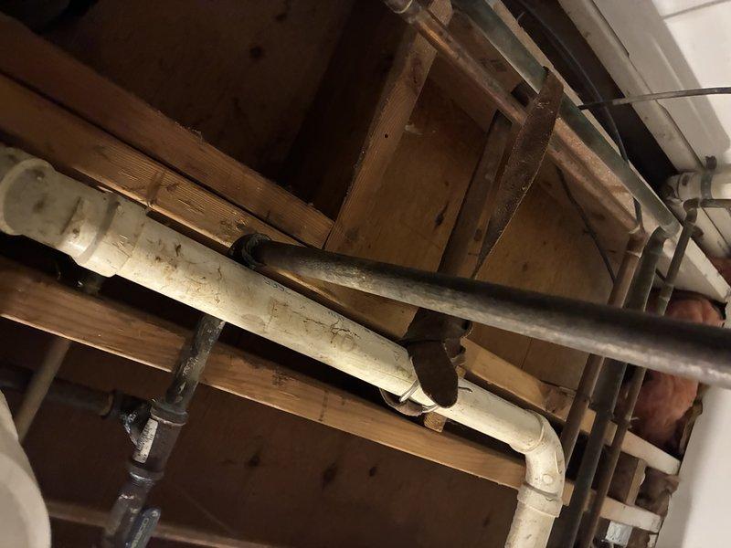 Completed plumbing repair in crawlspace/basement area involving inspection and potential replacement of PVC and copper pipe components. Service included maintenance of connections at valve junction points where the supply system interfaces with drainage components within the structural framework.