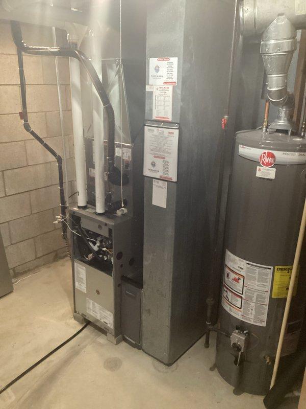 Completed installation of new furnace in basement utility area, including connection of black ventilation pipes and proper integration with existing water heater system. Performed electrical connection work in attic/crawlspace, ensuring proper wiring to junction components and verifying compatibility with the home's ductwork system.