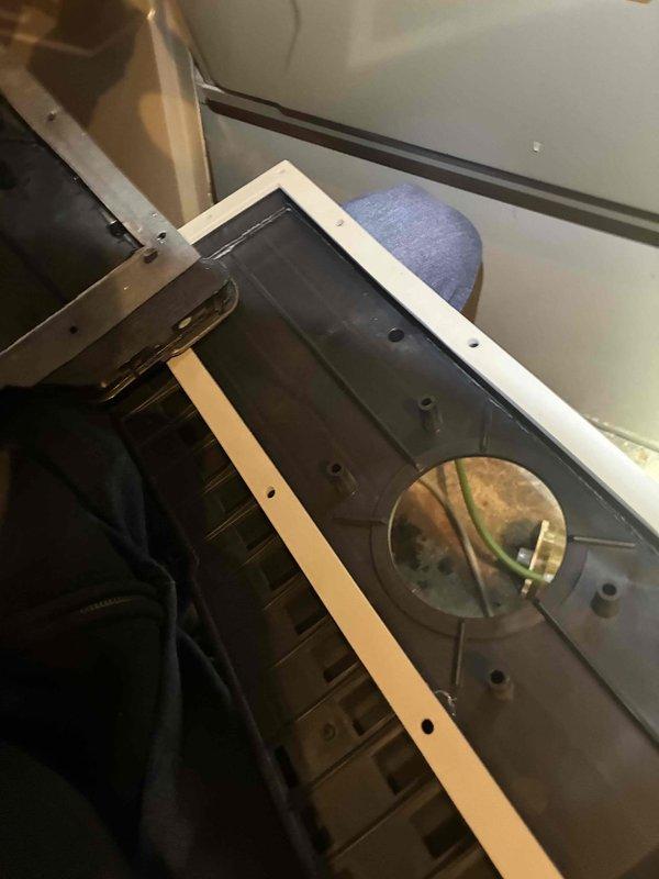 Performed diagnostic inspection on HVAC system revealing internal wiring issues. Accessed unit control panel, examined electrical components, and identified faulty connections within the wire bundles (yellow, green, blue, red, white). Restored proper functionality by reconnecting and securing loose connections to motor assembly.