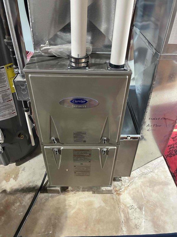 Responded to no-heat service call for Carrier Infinity furnace. Performed gas pressure verification test with digital manometer, confirming proper readings of 3.37/3.32 inWC within manufacturer specifications. Identified minor water staining near unit base which did not affect operation. System now functioning normally with proper heat output.