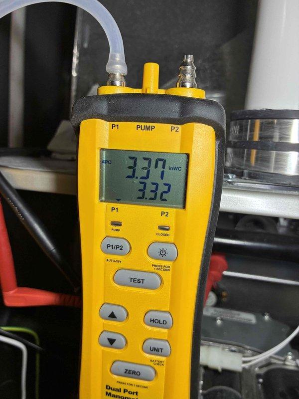 Responded to no-heat service call for Carrier Infinity furnace. Performed gas pressure verification test with digital manometer, confirming proper readings of 3.37/3.32 inWC within manufacturer specifications. Identified minor water staining near unit base which did not affect operation. System now functioning normally with proper heat output.