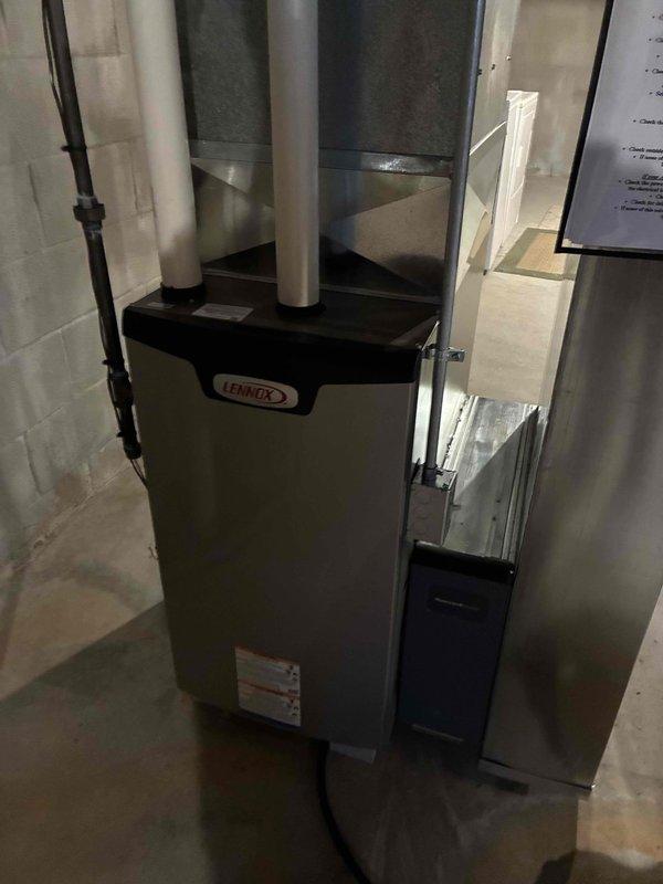 Completed follow-up service call on Lennox furnace system. Inspected basement installation and verified proper functioning of ductwork connections and gas piping. Checked and recalibrated Honeywell ProSeries thermostat which was displaying correct temperature (77°F heat setting) with temporary hold feature engaged.