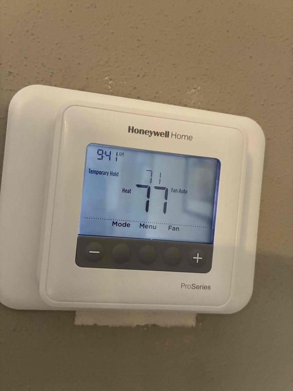 Completed follow-up service call on Lennox furnace system. Inspected basement installation and verified proper functioning of ductwork connections and gas piping. Checked and recalibrated Honeywell ProSeries thermostat which was displaying correct temperature (77°F heat setting) with temporary hold feature engaged.