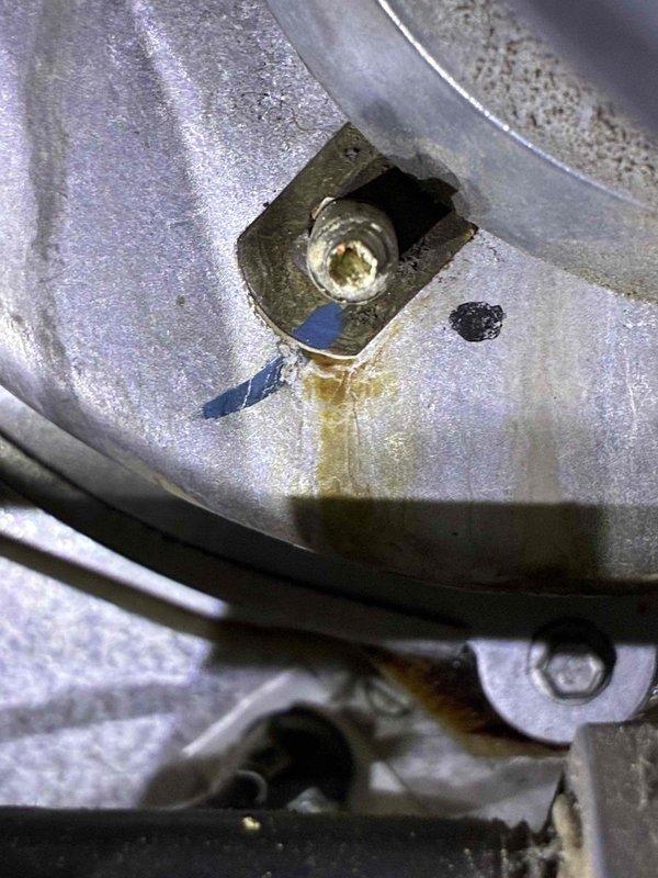 Performed standard HVAC tune-up service and identified oil leak from compressor fitting. Tightened fasteners on unit mounting bracket to prevent vibration damage. System now operating within normal parameters but will require follow-up maintenance to address the developing oil leak.