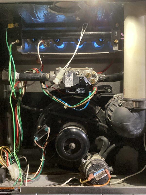 Responded to No Heat call for aging furnace (10+ years). Diagnosed ignition issues and confirmed proper flame pattern at burner assembly after service. Also inspected basement sump pump system, verifying proper discharge line connections and functionality to prevent water damage. System now operating within specifications.