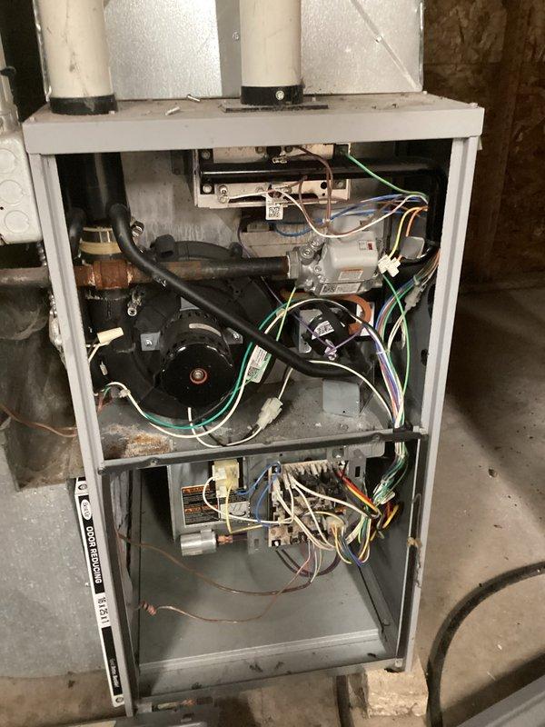 Diagnosed no-heat complaint on aging system using Fieldpiece manometer, which confirmed low pressure readings of 35.1 across inducer assembly. Inspected blower compartment and found significant dust accumulation on fan motor assembly affecting airflow. Cleaned blower wheel, verified proper operation of safety switches, and restored heat function to manufacturer specifications.