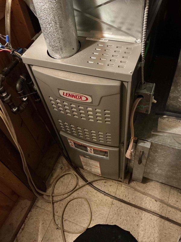 Performed routine inspection and maintenance on Lennox furnace. Opened access panel to inspect blower assembly, electrical connections, and control board; all components in working order. Verified proper operation of motor and electrical systems with no issues detected.