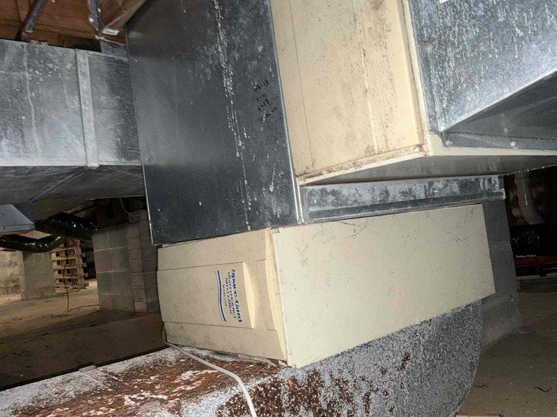 Conducted inspection of existing HVAC system located in crawl space, documenting condition of galvanized ductwork and deteriorating air handler unit. Evaluated plumbing connections including PVC piping (Freedom PVC 1120 SCH 40) and electrical wiring to determine replacement requirements. Recommended full system replacement due to visible water damage on foundation surface beneath unit and aging components.