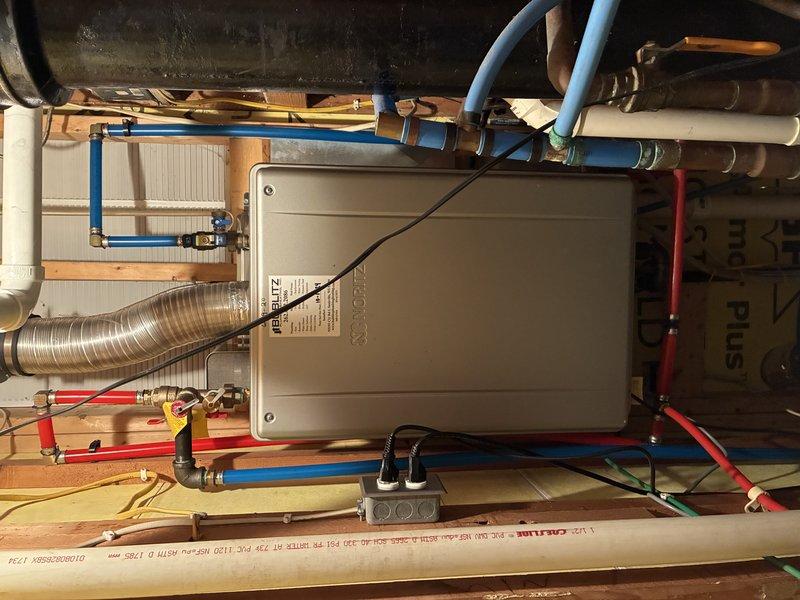 Performed comprehensive tankless water heater flush service to remove mineral buildup and sediment. Inspected clear sediment trap and drainage components, confirming proper functioning of condensate system. Verified all connections, valves, and PEX supply lines were secure and operating correctly after service completion.