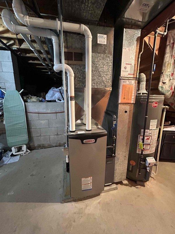 Successfully completed installation of a new high-efficiency furnace in basement utility area. Connected unit to existing PVC exhaust system with proper venting. System was tested and verified to be operating according to manufacturer specifications.