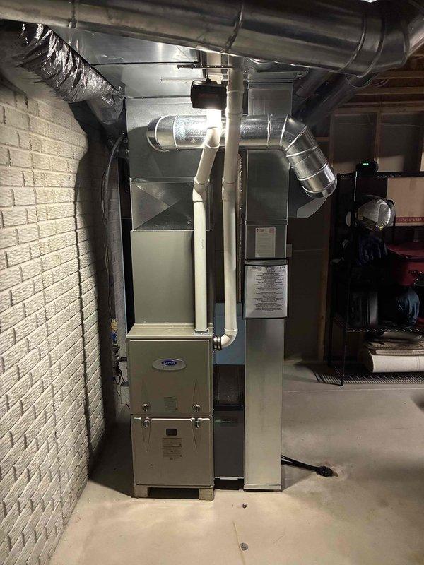 Conducted comprehensive assessment of existing HVAC system in residential utility room, identifying aging Carrier furnace unit requiring replacement. Documented current installation featuring metal ductwork, connected humidifier, and proximity to water heater for proper replacement planning. Prepared estimate for complete system replacement with appropriately sized equipment to integrate with existing ductwork configuration.