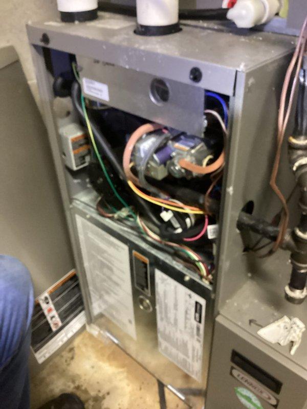 Performed diagnostic assessment on 10+ year old heating system not producing heat. Inspected control board and wiring connections in furnace, finding loose connections and slight corrosion on the main circuit board terminals. Reconnected and secured all wiring harnesses, particularly focusing on the multicolored control wires connected to the circular component. Cleaned corrosion from terminals and verified proper voltage to the ignition system. System now operating correctly with consistent flame ignition and proper heating cycle.