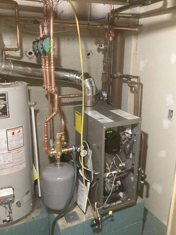 Installed new high-efficiency boiler system with three circulator pumps in parallel configuration. Completed all copper piping connections between boiler, domestic water heater, and existing distribution system. Mounted expansion tank and verified proper system pressure and operation after installation.