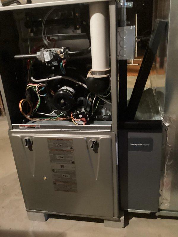 Performed seasonal tune-up on gas furnace with Honeywell accessory. Removed access panels for comprehensive inspection of internal components including blower motor assembly and control board. Conducted temperature testing using UEI EMT1 digital meter, confirming system operating temperature at 32°. All electrical connections, wiring, and venting (PVC) were inspected and verified to be in proper working condition.