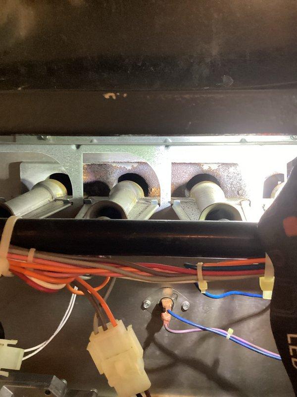 Responded to no-heat complaint for aging system (10+ years old). Diagnosed faulty blower motor after examining heat exchanger and burner assembly. Removed failed blower motor assembly, installed new replacement motor and verified proper system operation. System now heating correctly with all components functioning within specifications.