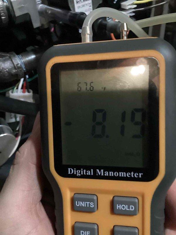 Completed installation of a complete HVAC system, including pressure and temperature testing of the system. Digital manometer readings verified optimal system performance with pressure at 8.12 inHg and ambient temperature at 61.6°F. Proper drainage was established with appropriate condensate line installation.
