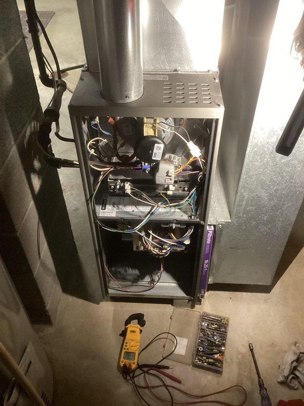 Performed comprehensive tune-up service on existing furnace system. Conducted electrical diagnostic testing with multimeter on control board components and verified proper voltage readings across all circuits. Inspected ductwork connections, focusing on main trunk line and elbow joint, confirming proper sealing and airflow integrity. All components were reassembled after inspection with no issues identified.