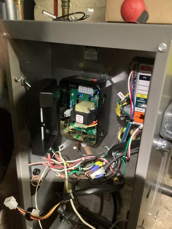 Performed diagnostics on control panel system by examining the circuit board and terminal connections. Inspected wiring integrity and electronic components within the control panel, focusing on the digital display functionality and connection points. Verified proper operation of the control module and secured all electrical connections before completing system testing.