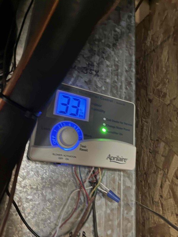 Performed IAQ inspection and discovered low relative humidity of 33% as displayed on customer's Aprilaire humidifier control unit. Inspected HVAC ducting system and identified condensation on metal panels, suggesting potential humidity regulation issues. Verified control unit wiring connections and proper mounting of ventilation components to ensure optimal system performance.